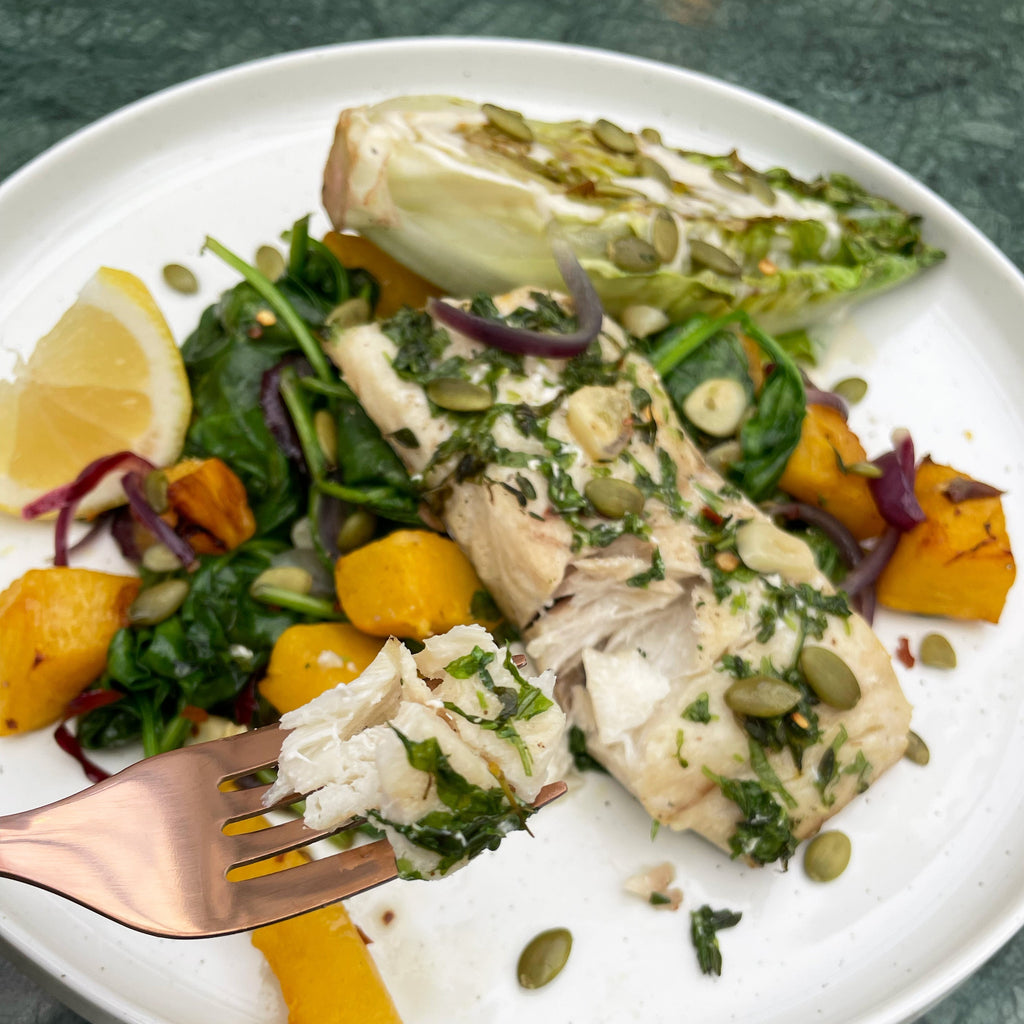 Tray Baked Stone Bass with a Herby Rub and Roasted Pumpkins, Red Onions, Garlic and Wilted Spinach